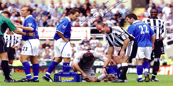 Robbie Savage lies of the pitch after being knocked out accidentally by Matt Messias